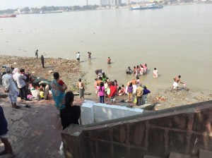 Ceremonial bathing and placing Saraswathi clay figures into the Ganges