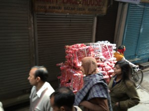 The volume of goods moving by bicycle--this is a cart of painted tables.