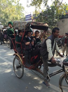 Girls going to school via bicycle rickshaw.