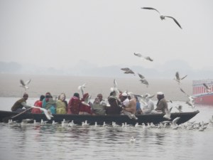 Boats full of pilgrims or tourists run a bit low in the water.