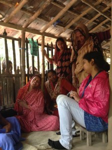 Sitting on the veranda talking with the community health worker, client and some of her family.