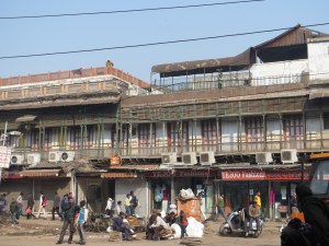 Major street repairs in front of old apartments.